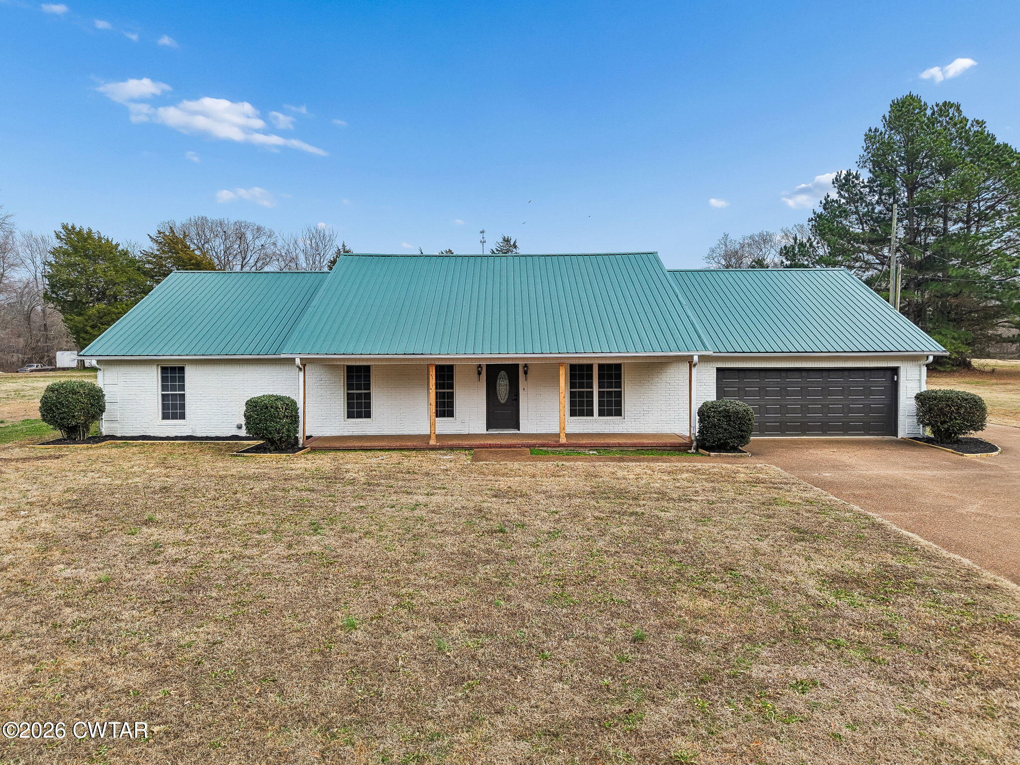 123 Walnut Hill Road Bells, TN 38006 - Photo 56 of 61 a front view of a house with a yard and garage