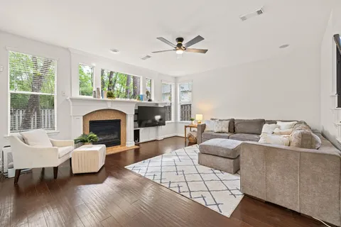 a living room with furniture a fireplace and a large window
