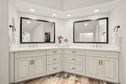 a bathroom with a sink vanity and mirror