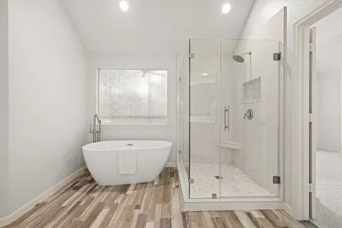 a bathroom with a shower a sink and a mirror