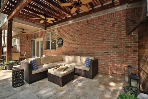 a view of a patio with table and chairs potted plants