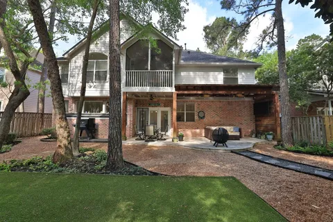 a front view of a house with garden and sitting area