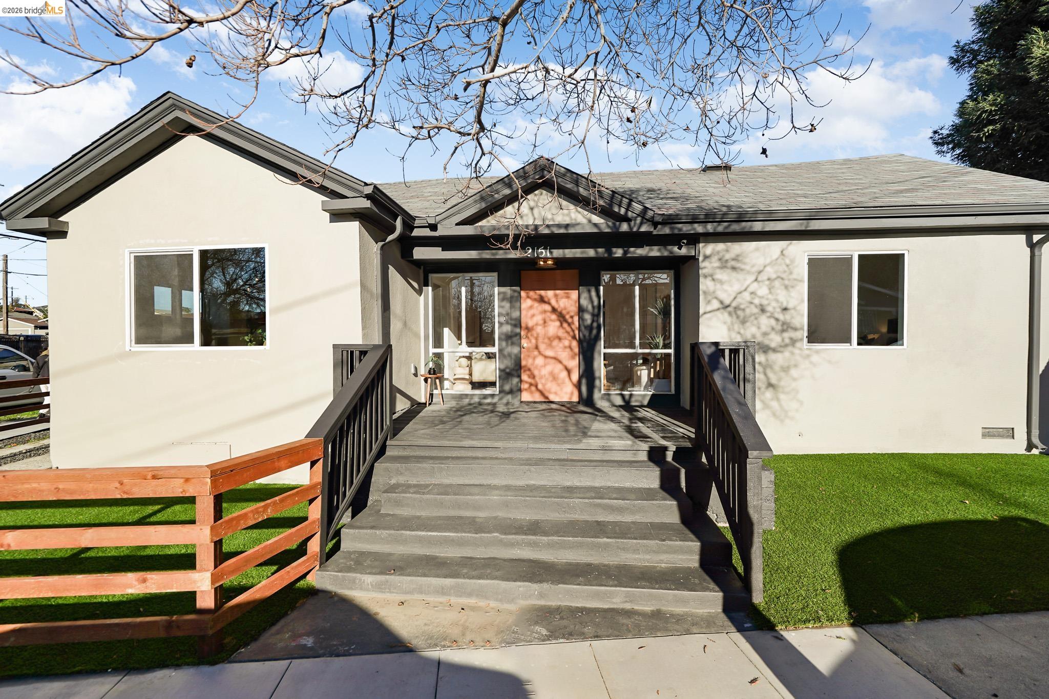 2151 Santa Rita Street Oakland, CA 94601 - Photo 45 of 46 Bungalow-style home with a shingled roof, stucco siding, and a front lawn
