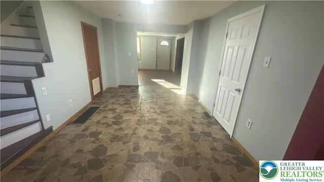 a view of a hallway view with staircase