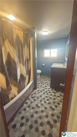 a bathroom with a mirror and a shower
