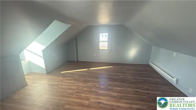 a view of room with window and wooden floor