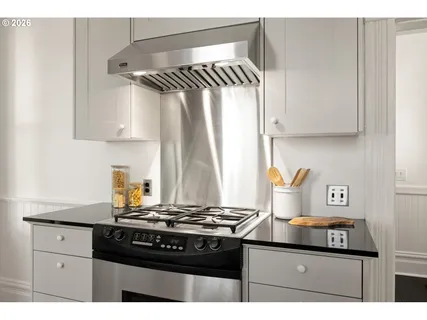 a kitchen with a stove and a cabinets