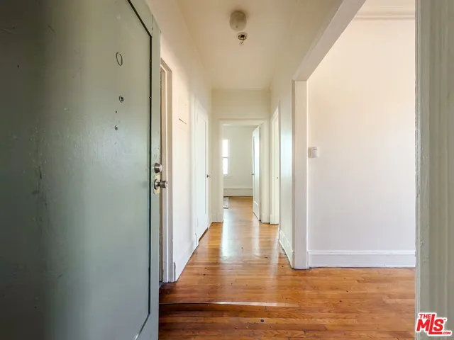 a view of a hallway with wooden floor