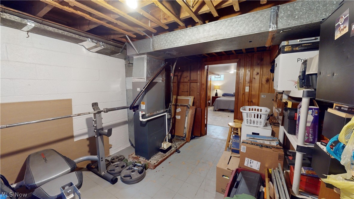 343 Canton Road Akron, OH 44312 - Photo 31 of 37 Basement featuring wood walls, tile flooring, and heating utilities
