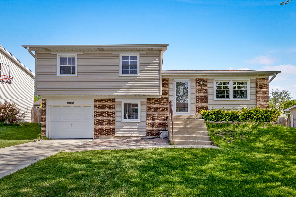 1680 Bicek Drive Hoffman Estates, IL 60192 - Photo 1 of 33 a front view of a house with garden