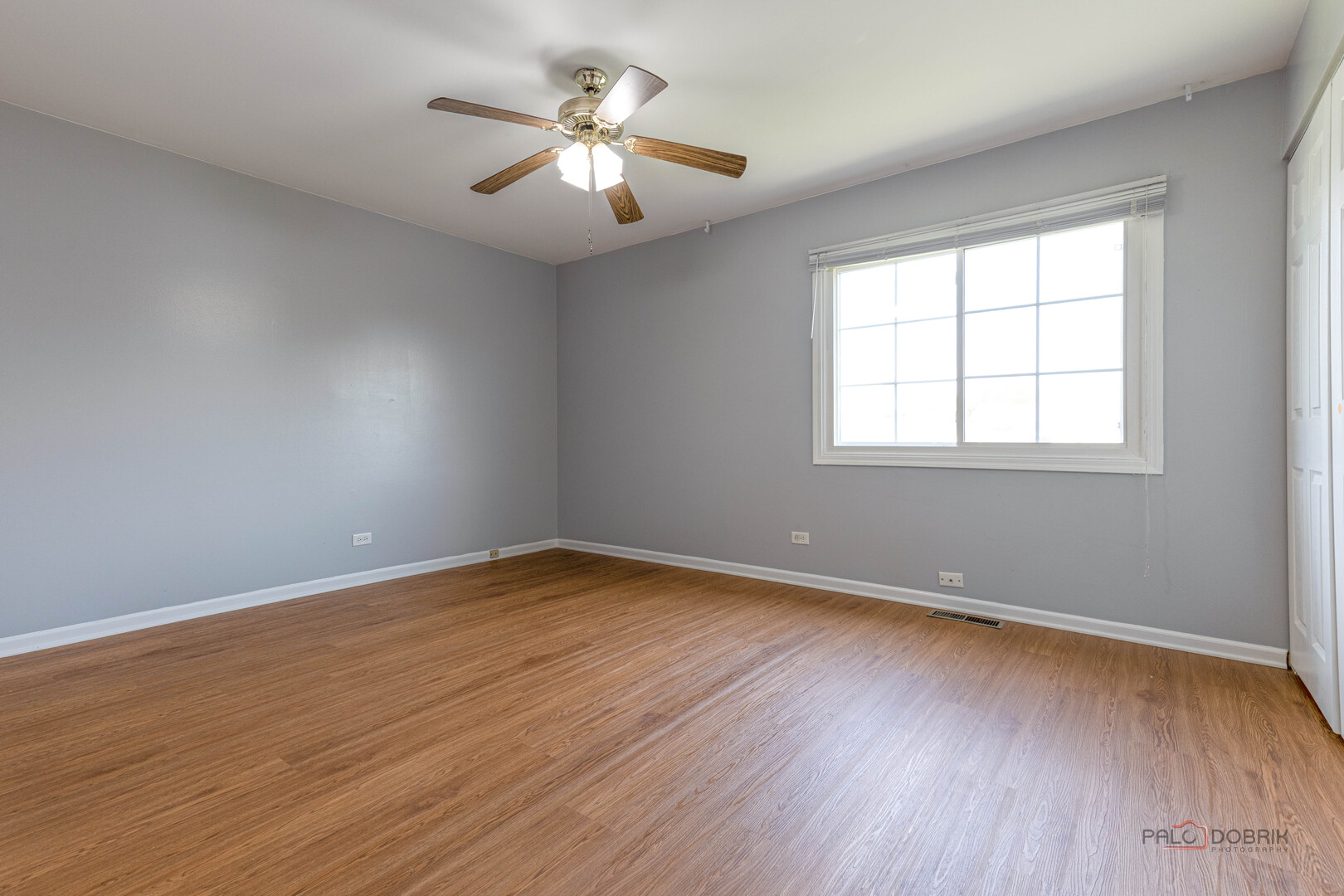 1680 Bicek Drive Hoffman Estates, IL 60192 - Photo 20 of 33 an empty room with wooden floor and windows