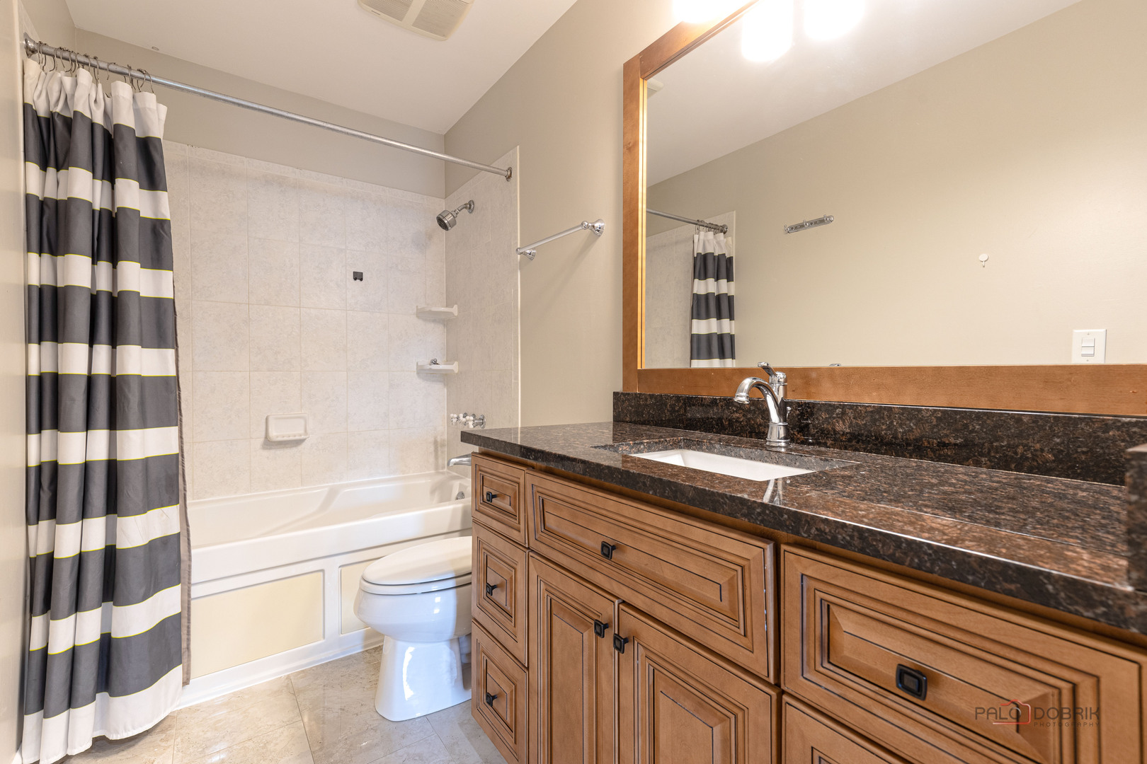 1680 Bicek Drive Hoffman Estates, IL 60192 - Photo 21 of 33 a bathroom with a granite countertop sink toilet a shower and a bathtub