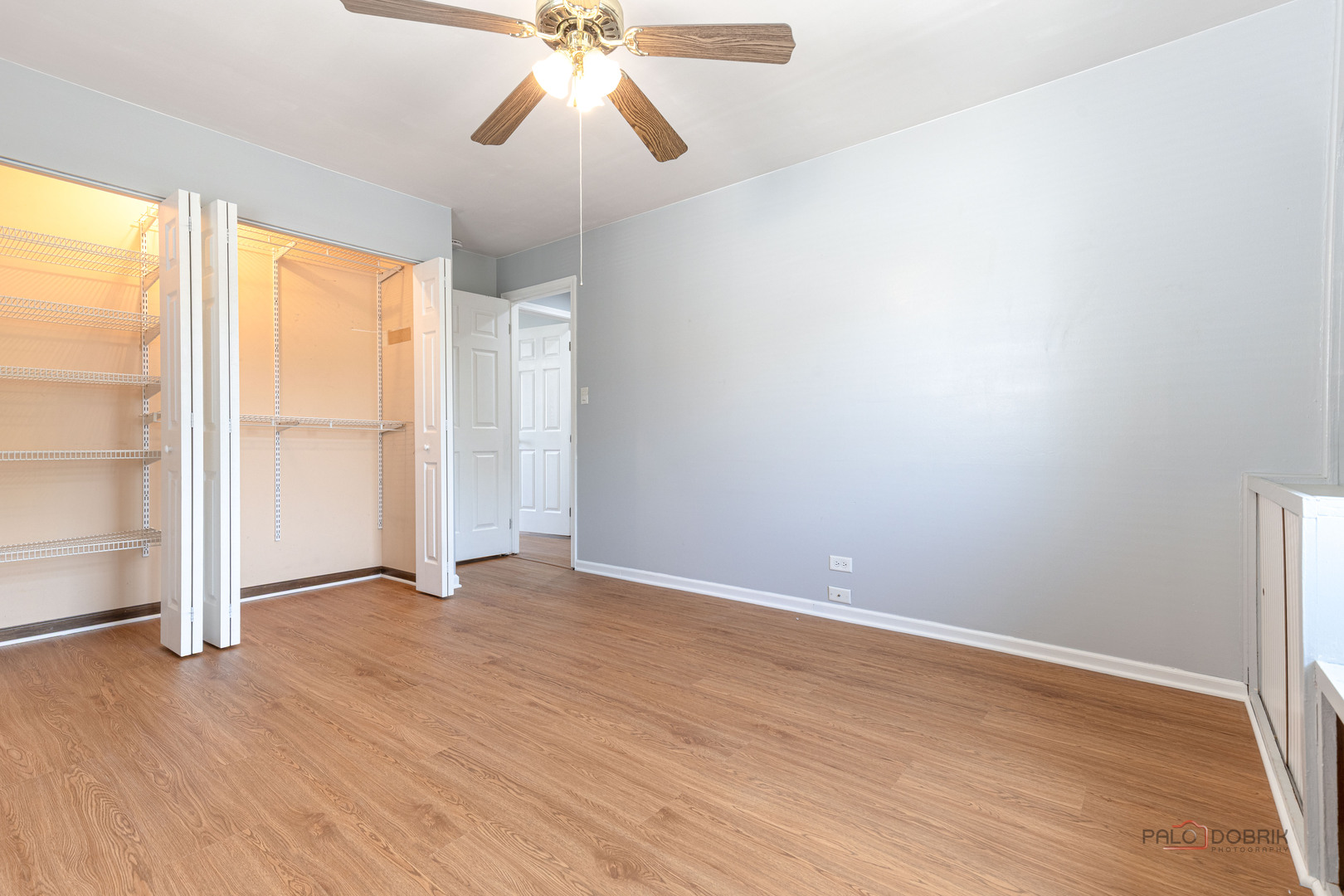 1680 Bicek Drive Hoffman Estates, IL 60192 - Photo 22 of 33 an empty room with wooden floor fan and windows