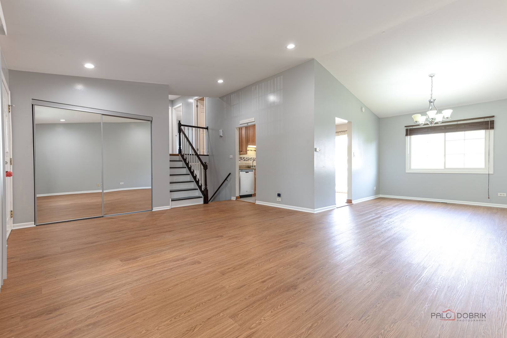 1680 Bicek Drive Hoffman Estates, IL 60192 - Photo 7 of 33 an empty room with wooden floor and staircase