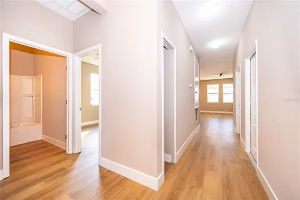 a view of a hallway with wooden floor