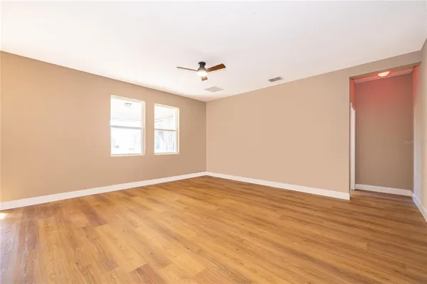 wooden floor in an empty room with a window