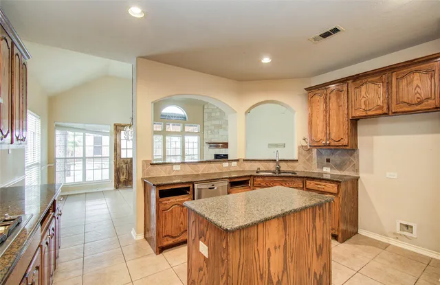 a kitchen with stainless steel appliances granite countertop a sink and a granite counter tops