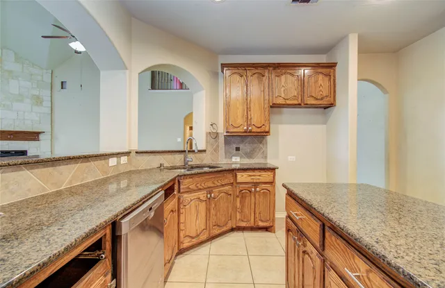 a view of an empty room with a fireplace and a window