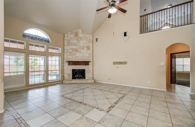a bathroom with a granite countertop sink a mirror and a bathtub