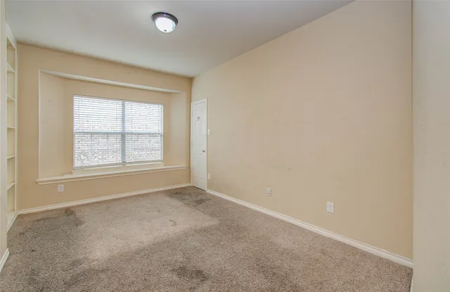 a view of a swimming pool with a yard and plants