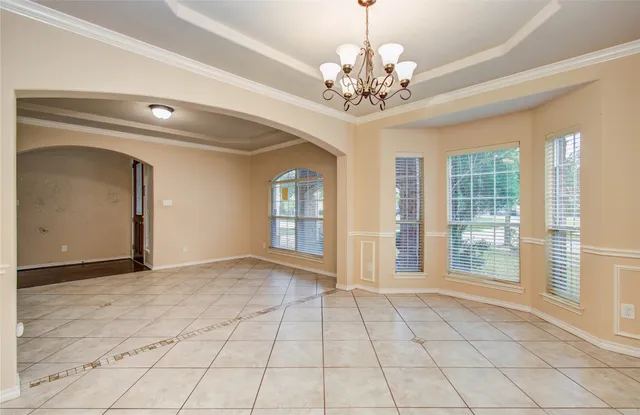 a kitchen with a stove a sink a refrigerator and a dining table