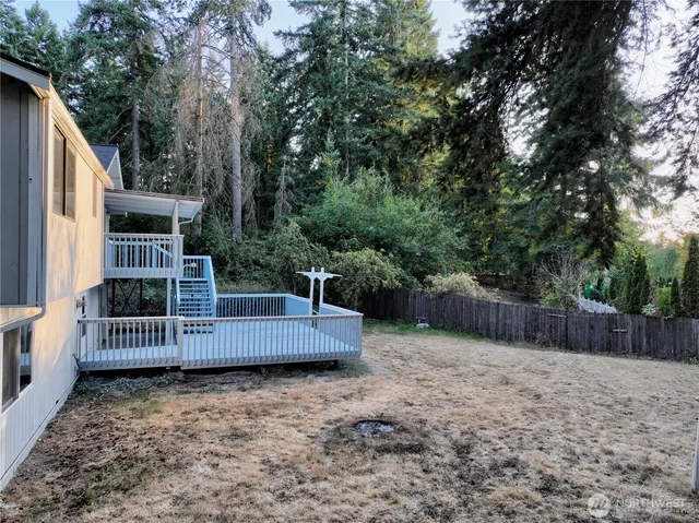 a living room with furniture a fireplace and a large window