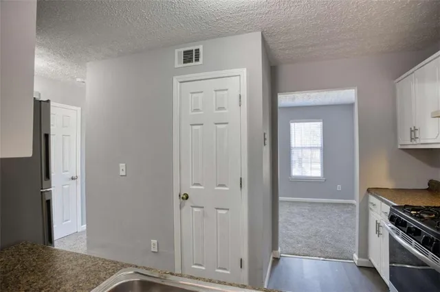 an empty room with a kitchen