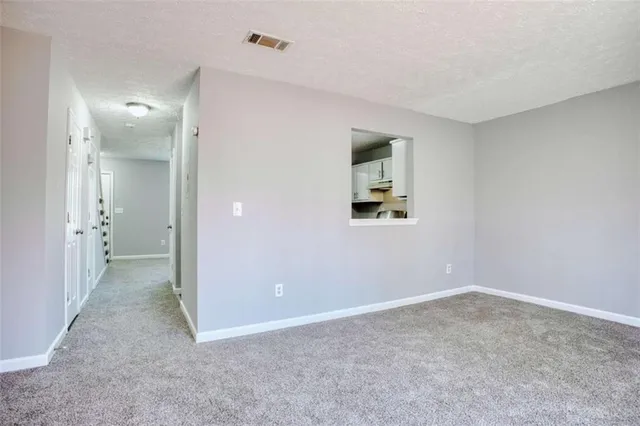 a kitchen with cabinets and a refrigerator