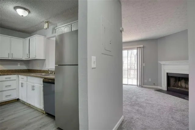 a kitchen with granite countertop a sink stove and cabinets