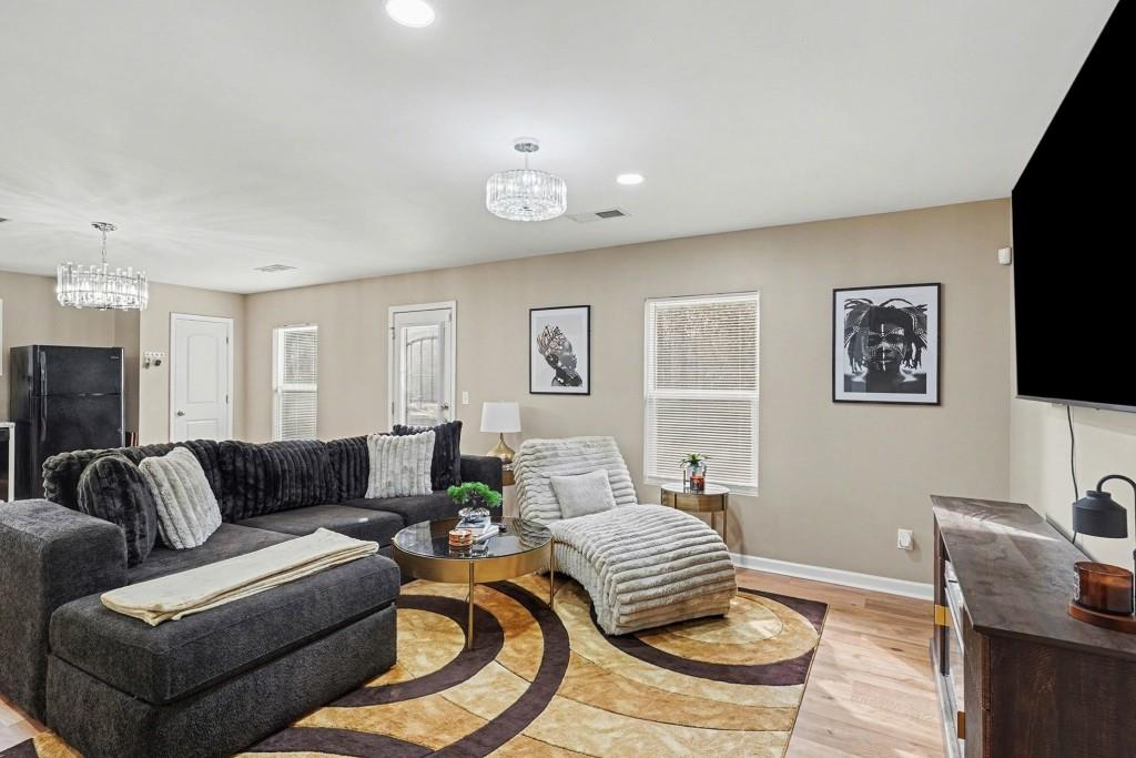 345 Arthurs Lane Covington, GA 30016 - Photo 11 of 33 a living room with furniture and a flat screen tv