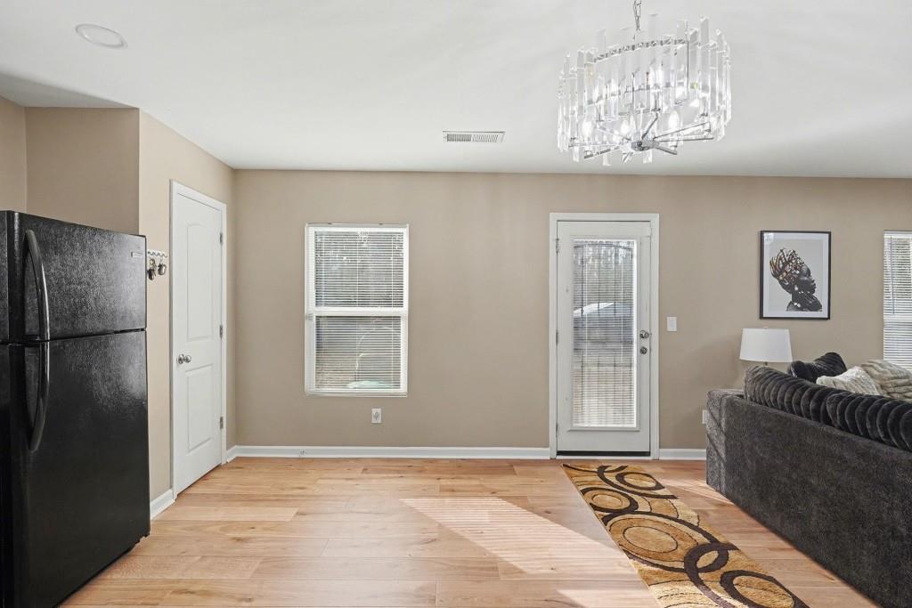 345 Arthurs Lane Covington, GA 30016 - Photo 12 of 33 a view of an empty room with a chandelier