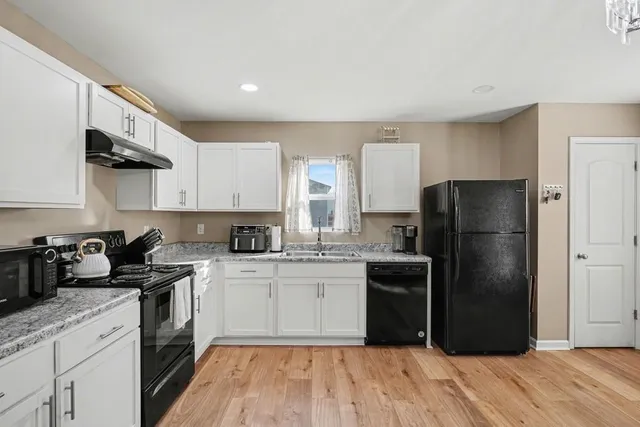 a kitchen with stainless steel appliances granite countertop a stove and cabinets