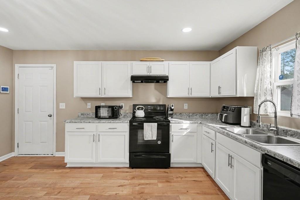 345 Arthurs Lane Covington, GA 30016 - Photo 14 of 33 a kitchen with stainless steel appliances granite countertop a stove and cabinets