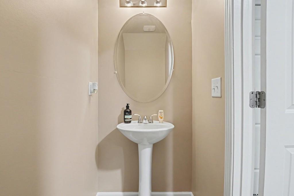 345 Arthurs Lane Covington, GA 30016 - Photo 15 of 33 a bathroom with a sink a mirror and shower