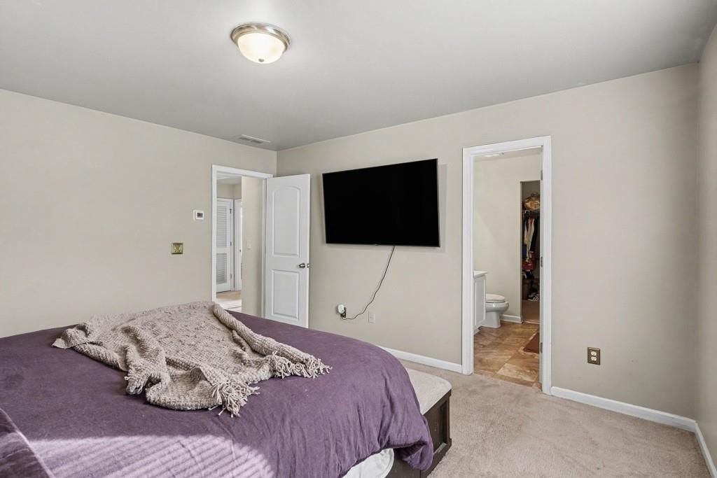 345 Arthurs Lane Covington, GA 30016 - Photo 19 of 33 a bedroom with a bed tv and a window