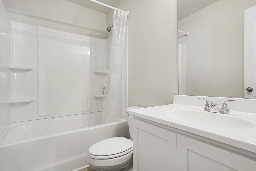 345 Arthurs Lane Covington, GA 30016 - Photo 22 of 33 a bathroom with a sink a toilet and shower