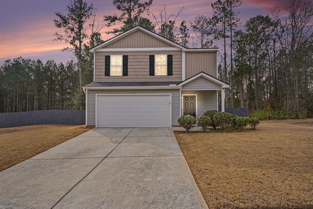 345 Arthurs Lane Covington, GA 30016 - Photo 31 of 33 a front view of a house with garden