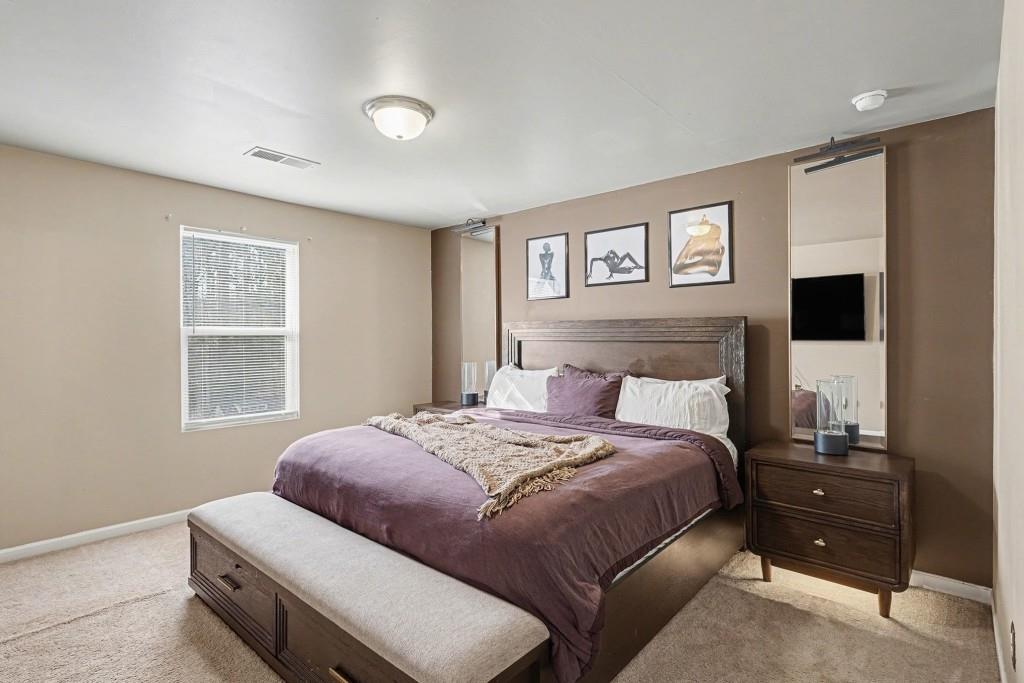 345 Arthurs Lane Covington, GA 30016 - Photo 4 of 33 a bedroom with a bed and a window