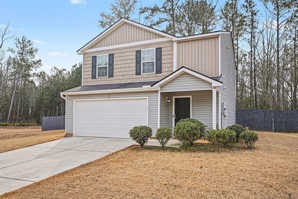 345 Arthurs Lane Covington, GA 30016 - Photo 8 of 33 a front view of a house with a yard and garage