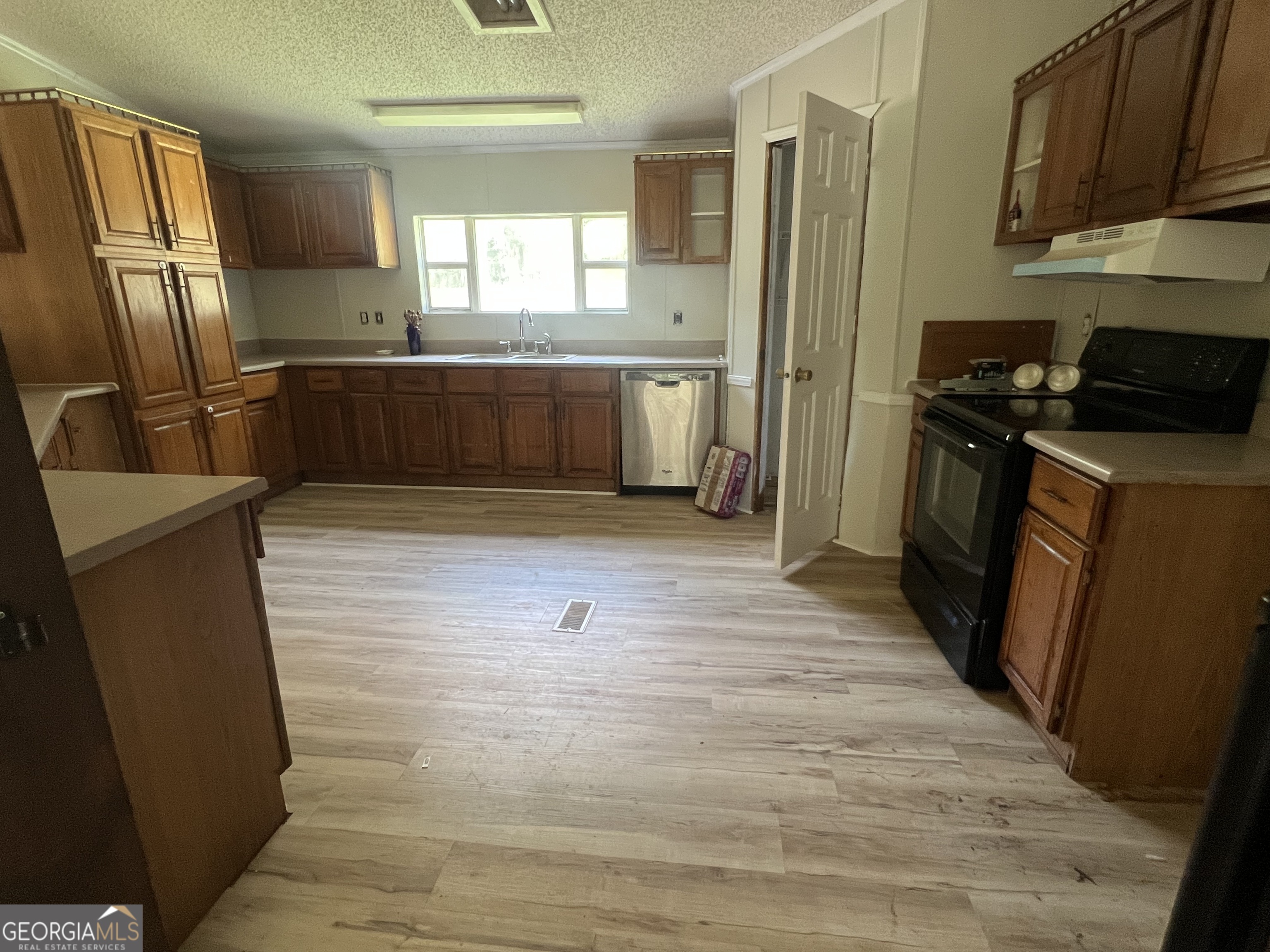 905 Natures Trail Forsyth, GA 31029 - Photo 13 of 59 a kitchen with granite countertop a refrigerator and a sink