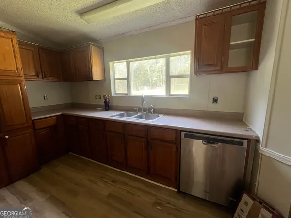 an empty room with windows and cabinet