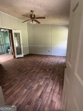 a view of a hallway to a livingroom with furniture wooden floor and window
