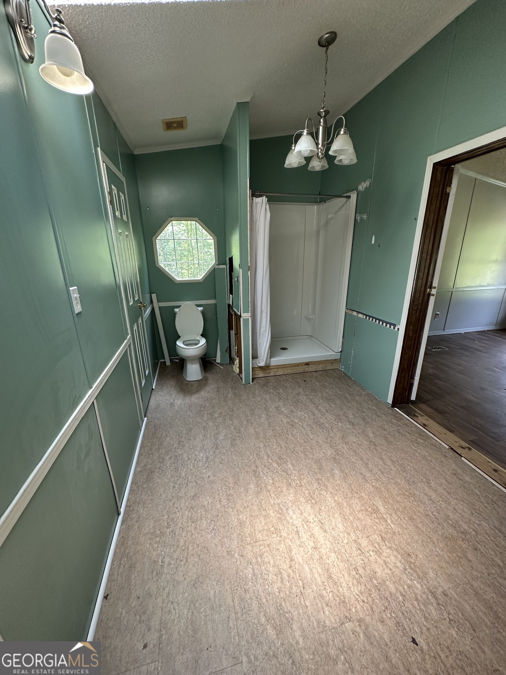 905 Natures Trail Forsyth, GA 31029 - Photo 28 of 59 a view of a hallway to a livingroom with furniture wooden floor and window