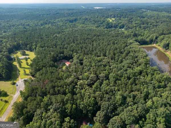 an aerial view of a house with a yard and outdoor seating