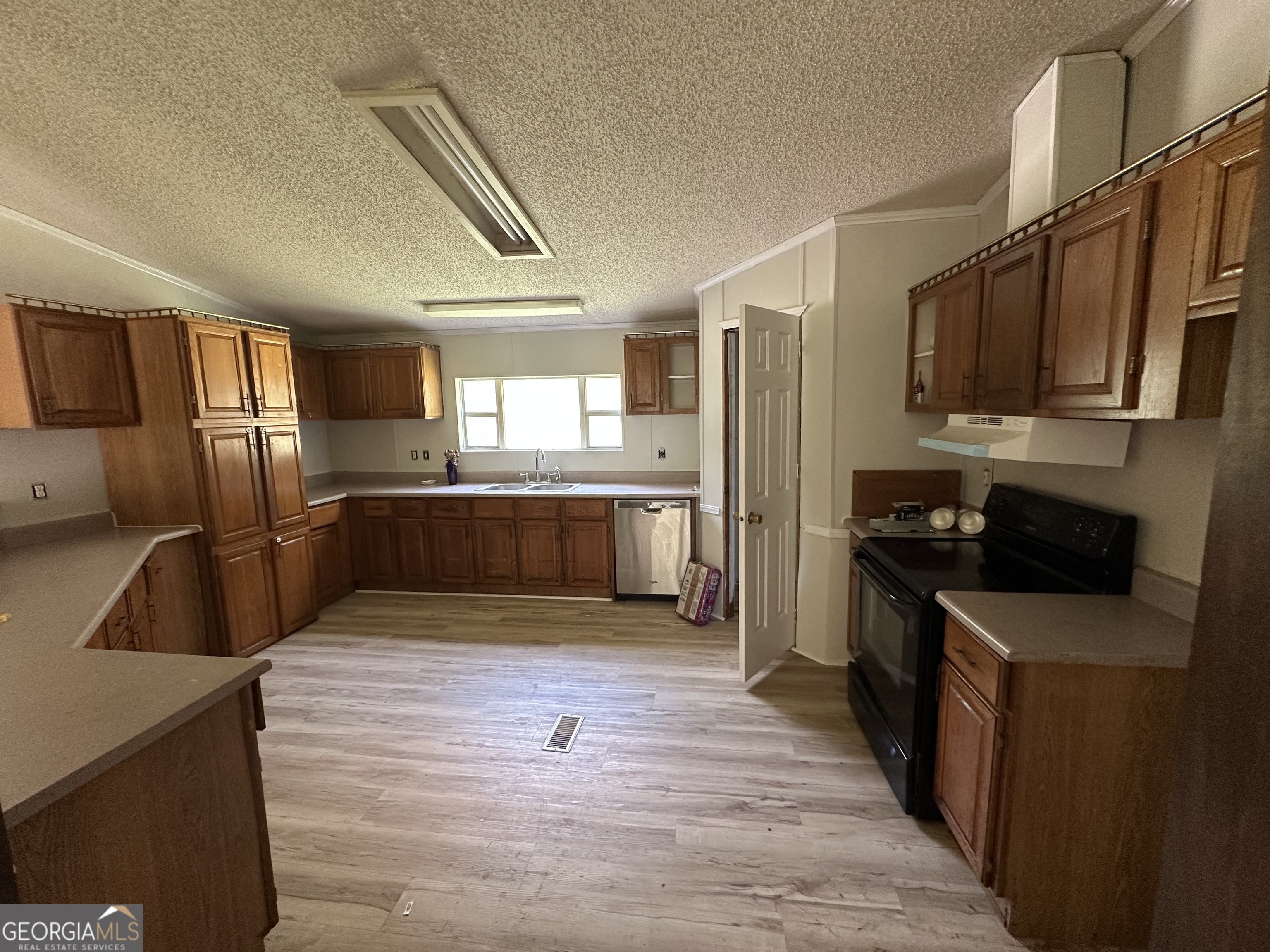 905 Natures Trail Forsyth, GA 31029 - Photo 42 of 59 a kitchen with stainless steel appliances wooden cabinets a refrigerator and a stove