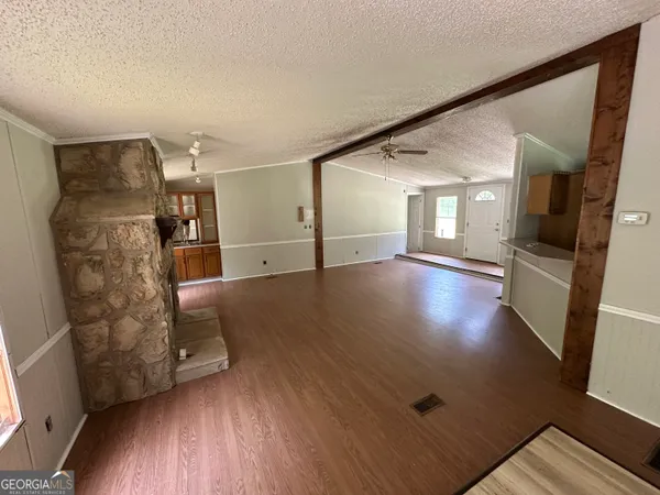 a view of a house with a yard and tree s