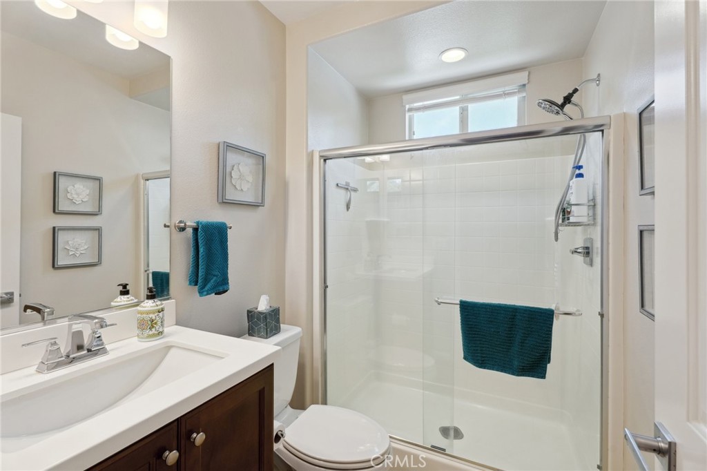 11266 Hutton Road Corona, CA 92883 - Photo 20 of 33 a bathroom with a sink toilet double vanity and shower