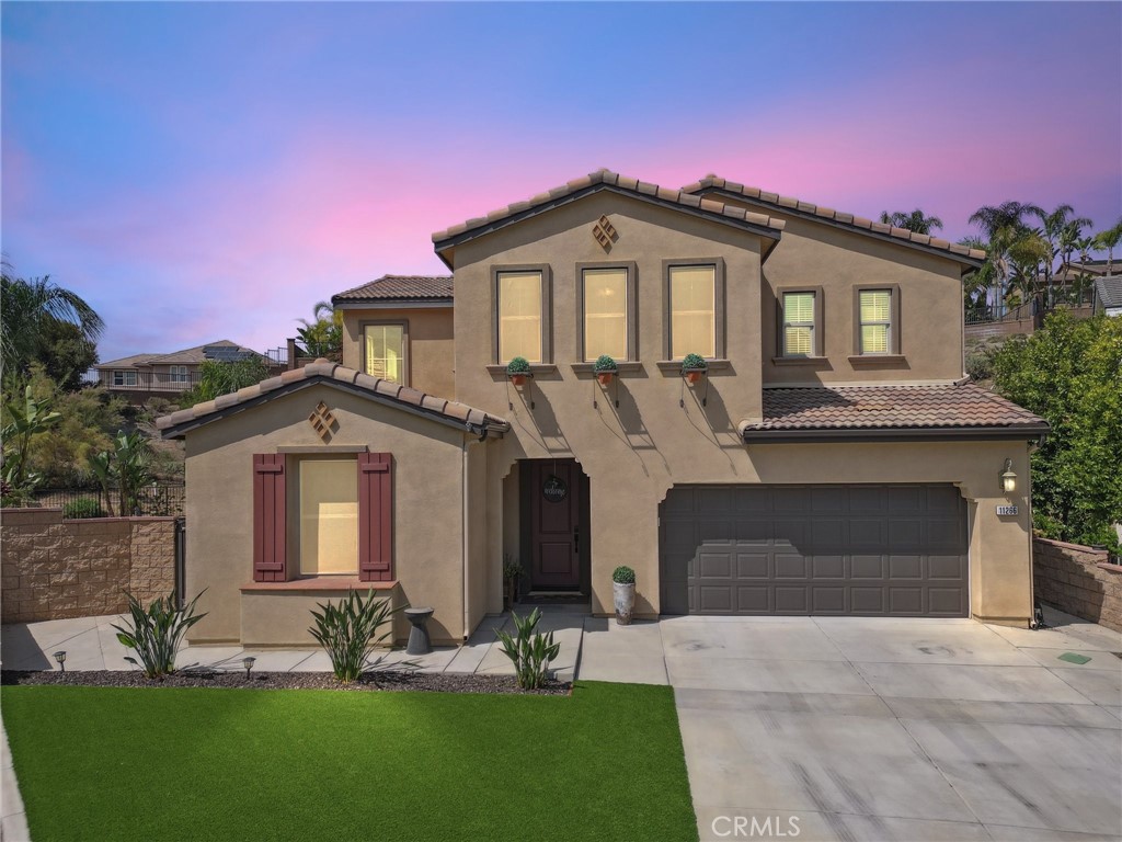 11266 Hutton Road Corona, CA 92883 - Photo 32 of 33 a front view of a house with a yard and garage