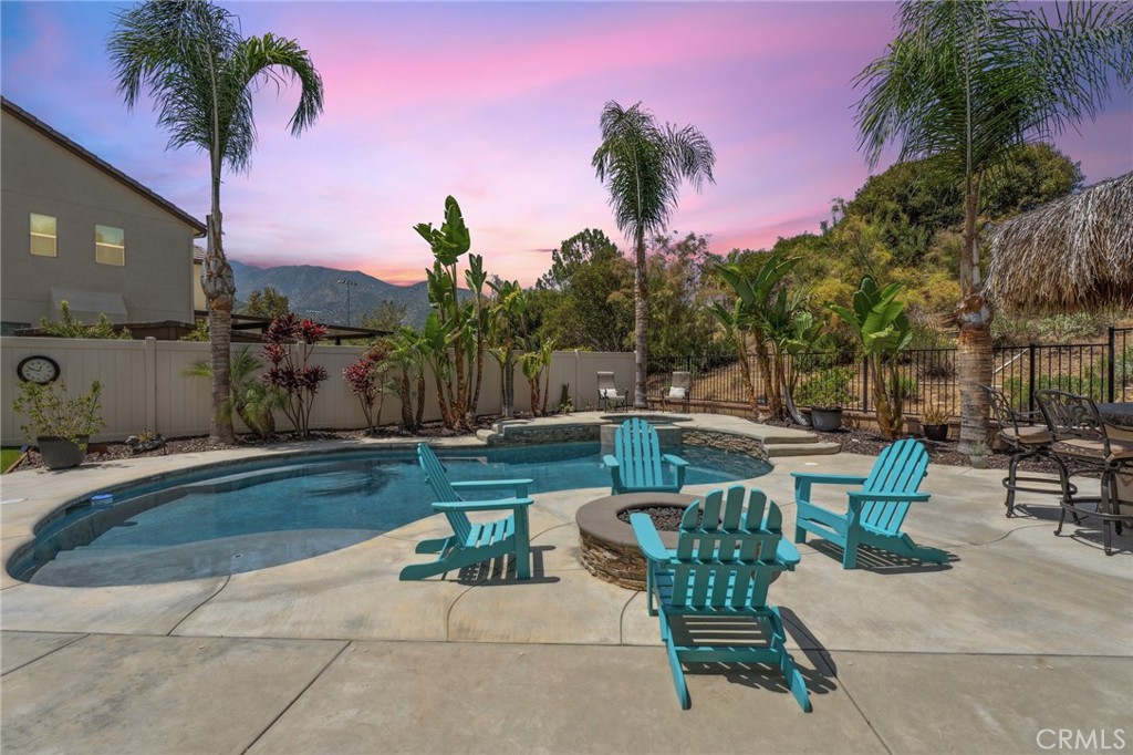 11266 Hutton Road Corona, CA 92883 - Photo 33 of 33 a view of a patio with table and chairs potted plants and palm tree