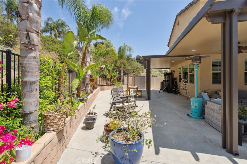 11266 Hutton Road Corona, CA 92883 - Photo 9 of 33 a view of a porch with chairs and potted plants